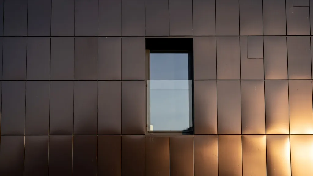 Dark bronze aluminum composite panel facade with a single window