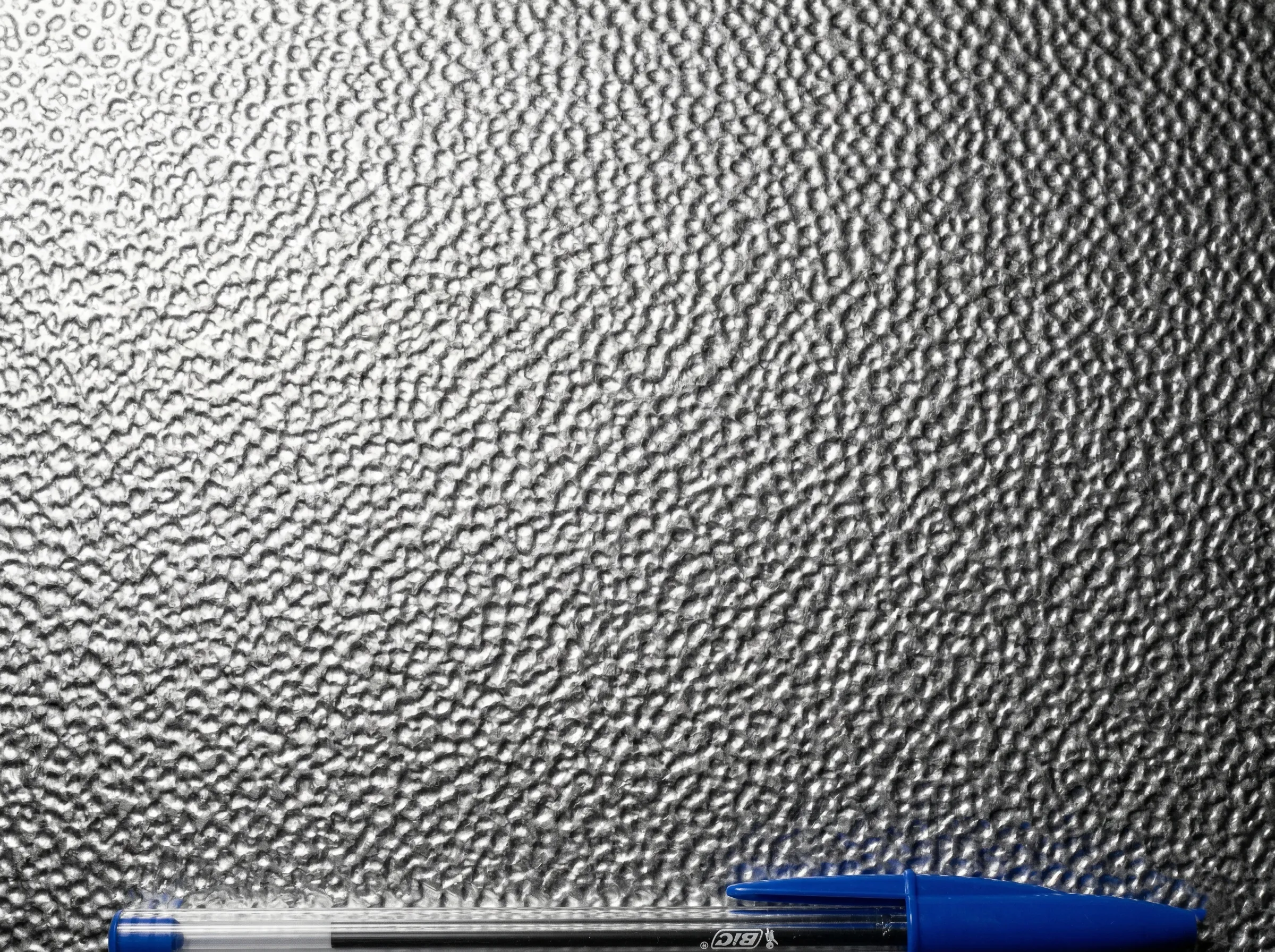 Close-up of stucco-embossed aluminum sheet texture