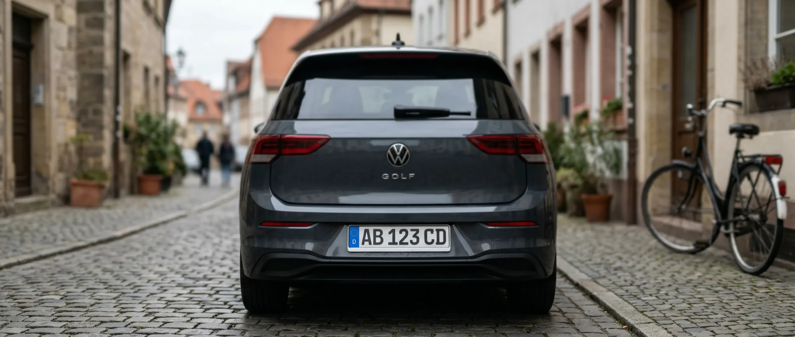 European license plate on the rear of a VW Golf on cobblestone