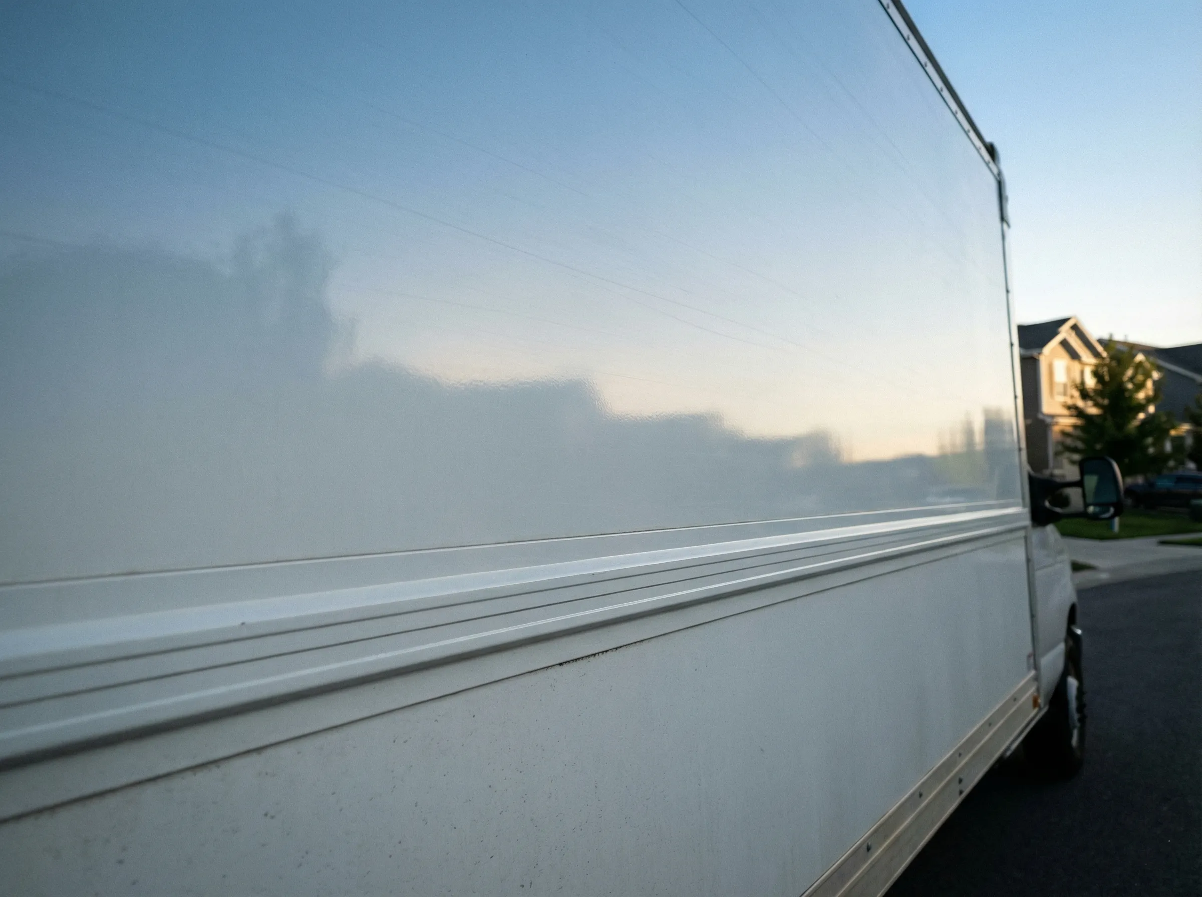 White aluminum-panel delivery truck, side view